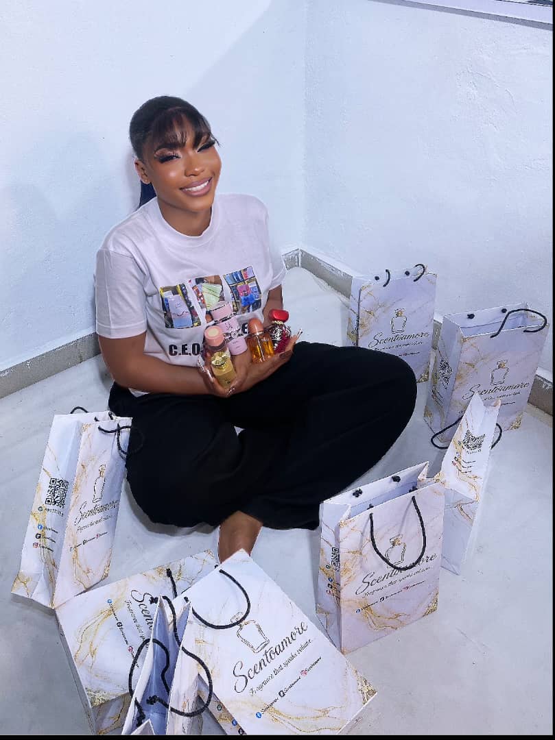 Scento Amore founder holding a selection of fragrances